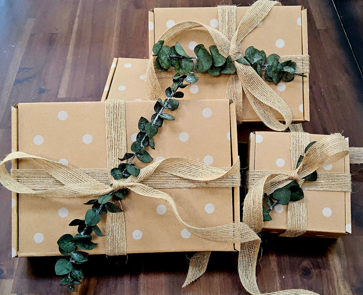InspireByMK premium gift box hand-wrapped with coordinating ribbon, fresh eucalyptus stem, and custom message insert, elegant presentation for any aromatherapy gift occasion