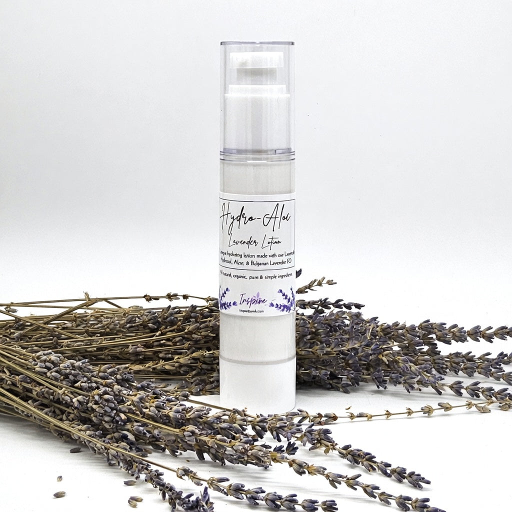 InspireByMK Hydro-Aloe Lavender Lotion airless pump bottle surrounded by dried purple lavender stems showing all-natural skincare moisturizer with lavender hydrosol, aloe vera, and Bulgarian lavender essential oil