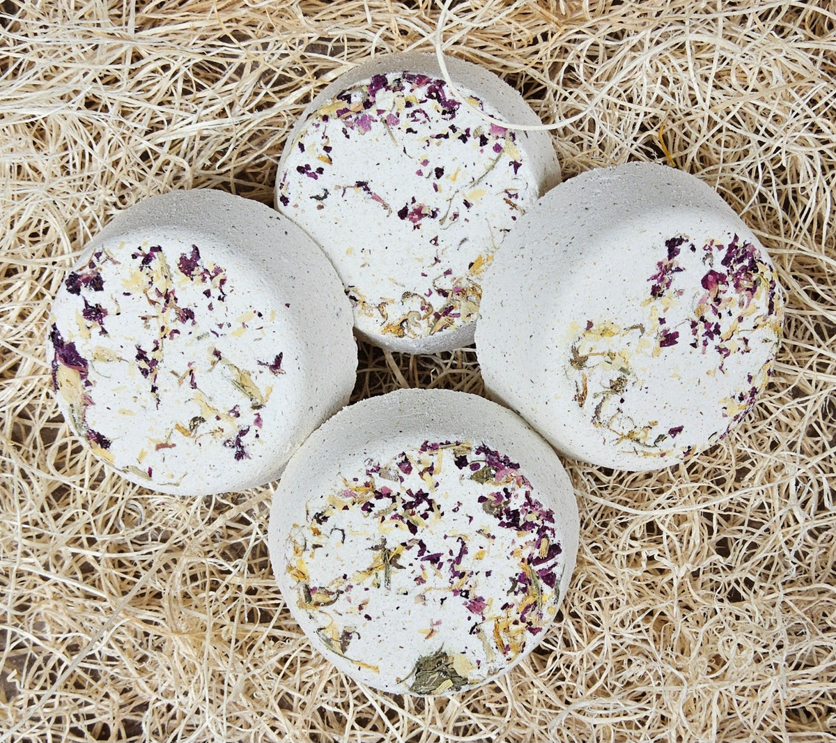 InspireByMK Restore shower steamer handcrafted essential oil blend of sandalwood, patchouli, and bergamot with rose hydrosol, cream-colored with dark purple and golden dried botanicals for grounding aromatherapy