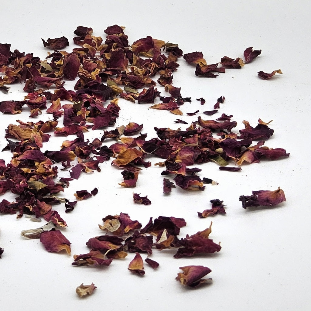 Dried deep red rose petals close-up showing natural botanical ingredient featured in InspireByMK Hydro-Aloe Rose Lotion for luxurious aromatherapy skincare hydration