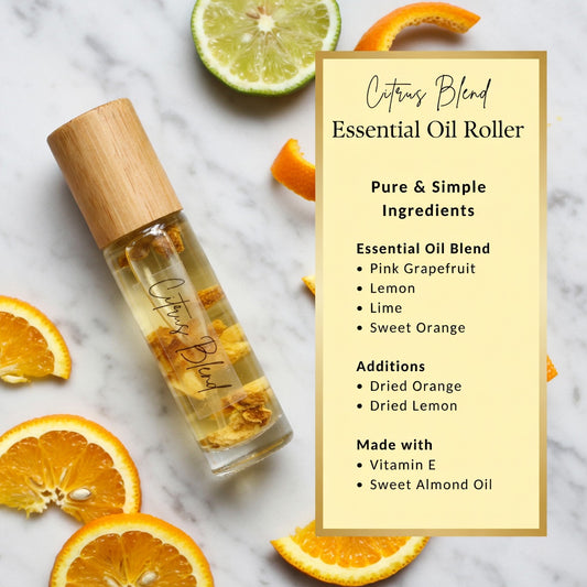 Citrus blend essential oil roller with pink grapefruit, lemon, lime and sweet orange, dried citrus peels on marble, uplifting natural roller.