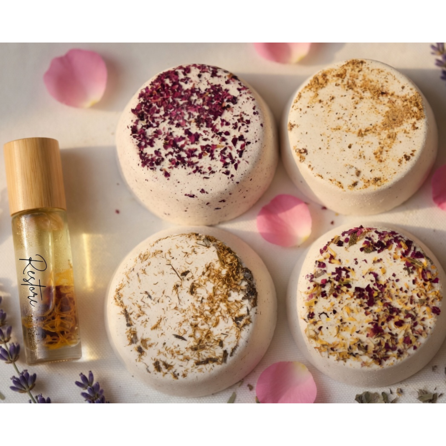 Aromatherapy essential oil roller with four luxury shower Steamers topped with rose petals and botanicals, natural handmade spa bath products