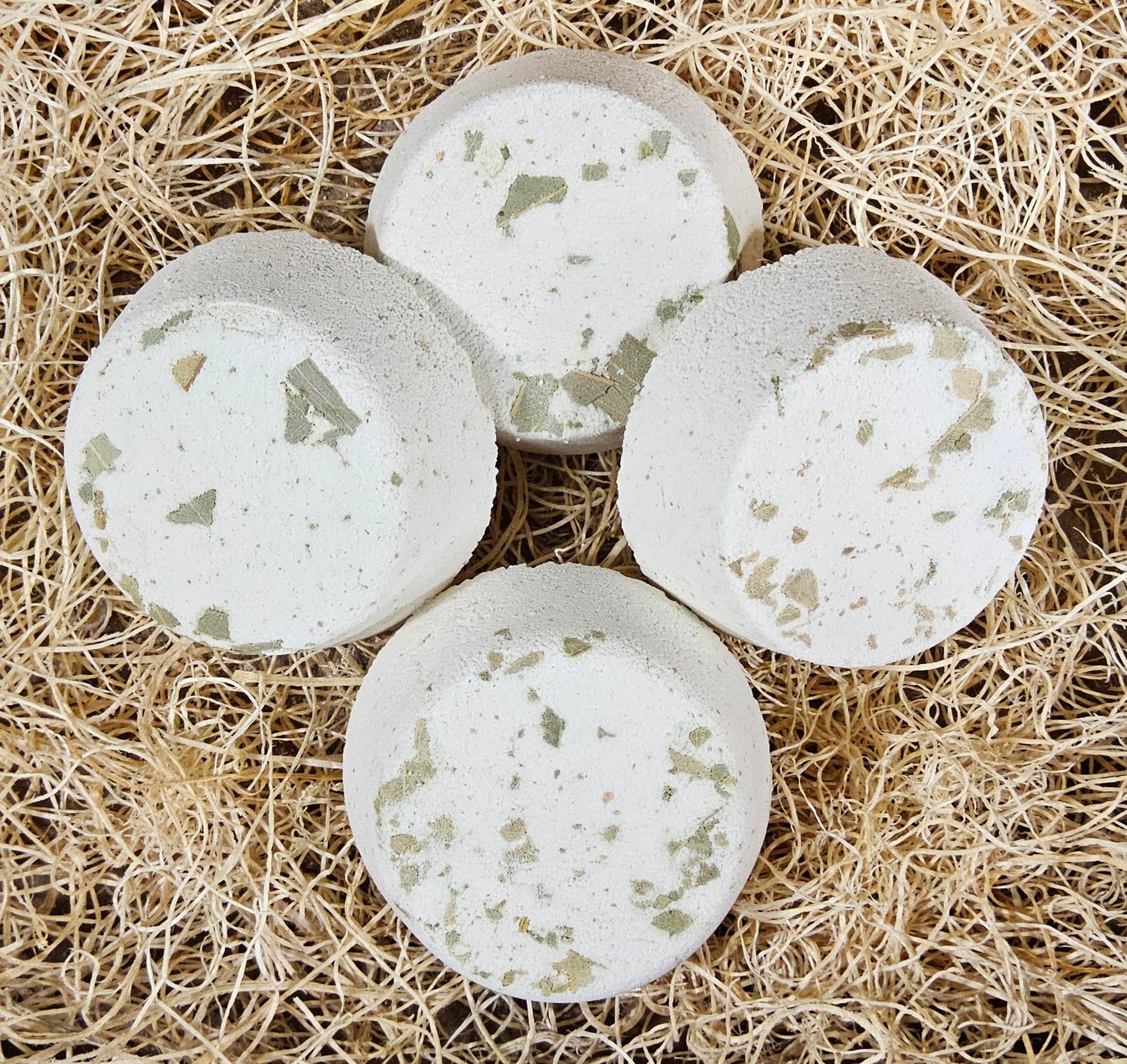 InspireByMK Eucalyptus shower steamer featuring pure eucalyptus essential oil with eucalyptus hydrosol, cream-colored handcrafted steamer with visible dried eucalyptus leaves for respiratory wellness and invigoration