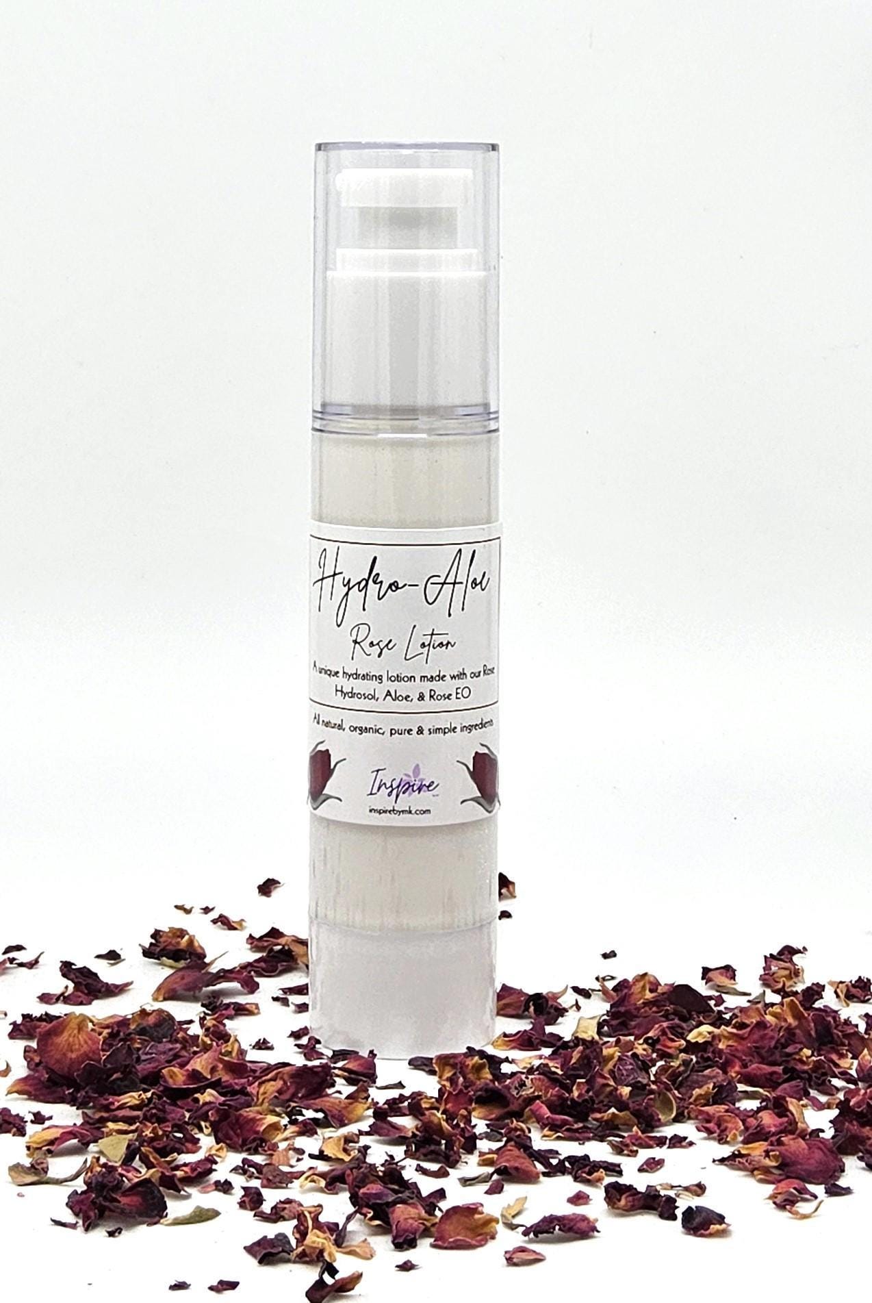 InspireByMK Hydro-Aloe Rose Lotion airless pump dispenser surrounded by dried dark red rose petals featuring all-natural hydrating lotion with rose hydrosol, aloe vera, and rose essential oil for skincare