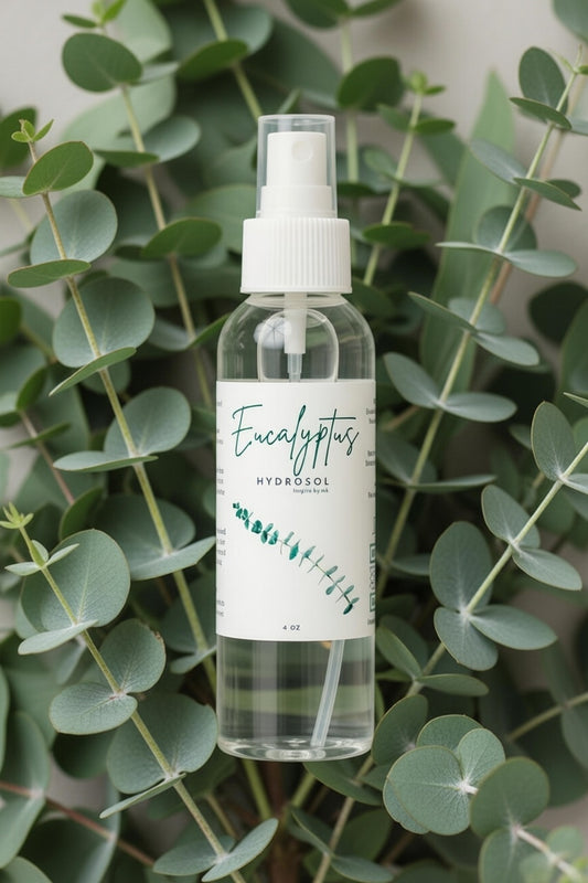 Eucalyptus Hydrosol 4oz spray bottle surrounded by fresh eucalyptus leaves. All natural organic eucalyptus hydrosol facial spray, room mist and congestion relief aromatherapy. Pure steam-distilled eucalyptus hydrosol for clear breathing, energizing scent and natural wellness.