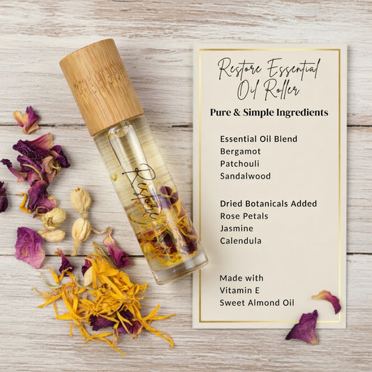 Restore essential oil roller infographic listing pure and simple ingredients including bergamot, patchouli, and sandalwood essential oils with rose petals, jasmine, and calendula. All natural grounding aromatherapy roller for emotional support and balance.