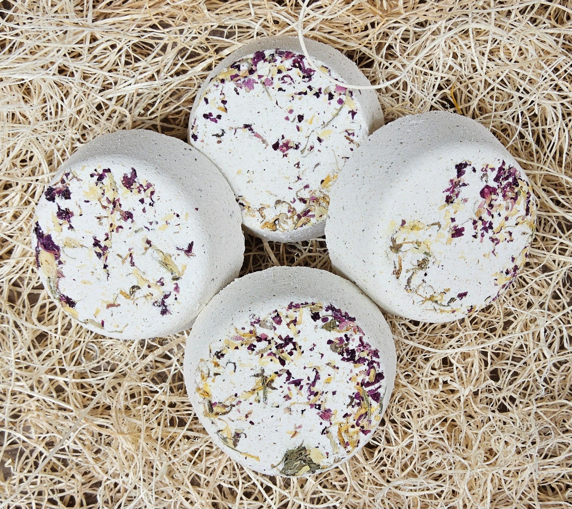 InspireByMK Restore shower steamer handcrafted essential oil blend of sandalwood, patchouli, and bergamot with rose hydrosol, cream-colored with dark purple and golden dried botanicals for grounding aromatherapy