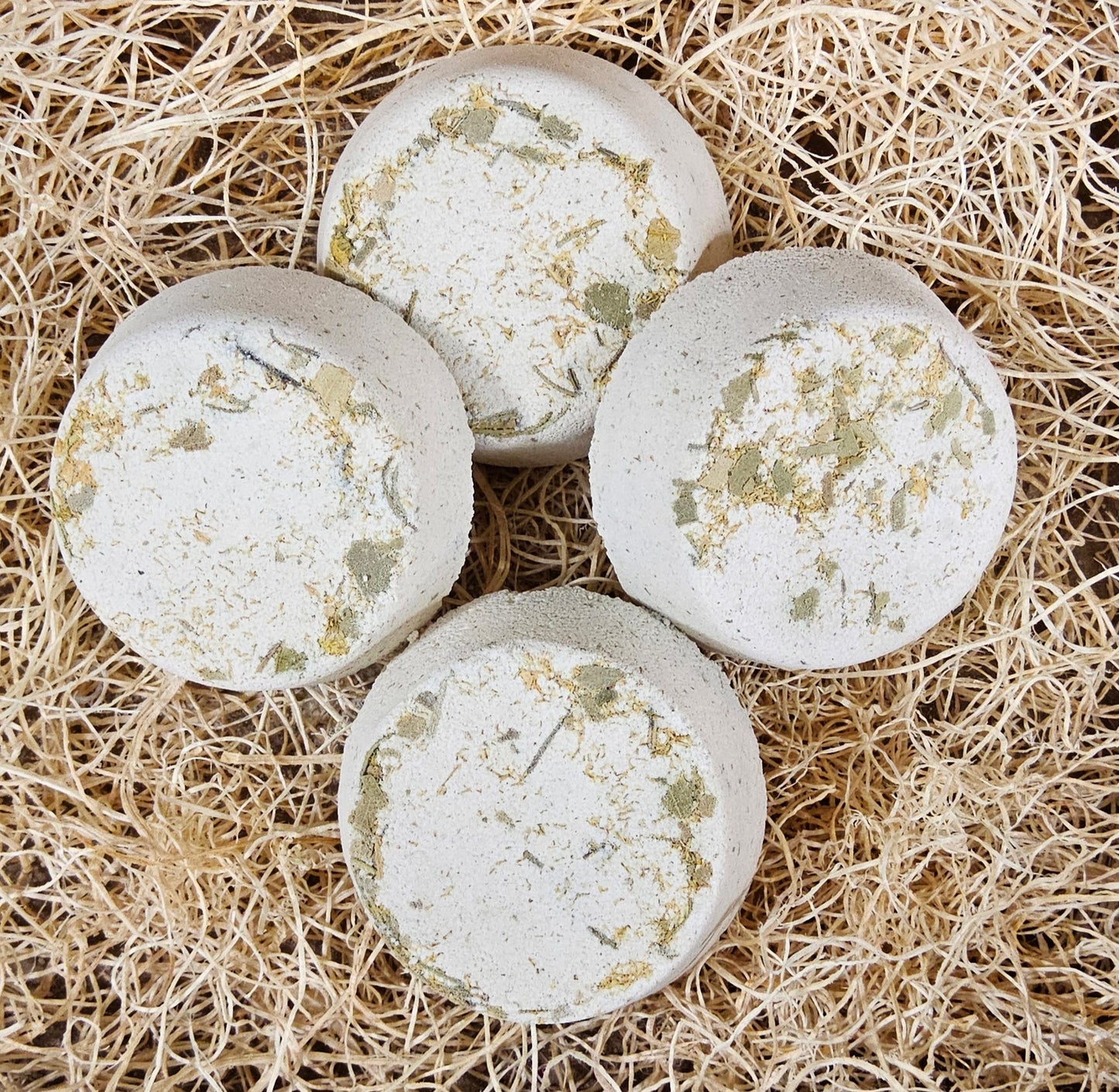 InspireByMK Revive shower steamer handcrafted blend of lemon, clove, eucalyptus, and rosemary essential oils with rosemary hydrosol, cream-colored with golden dried botanicals for energy and focus aromatherapy