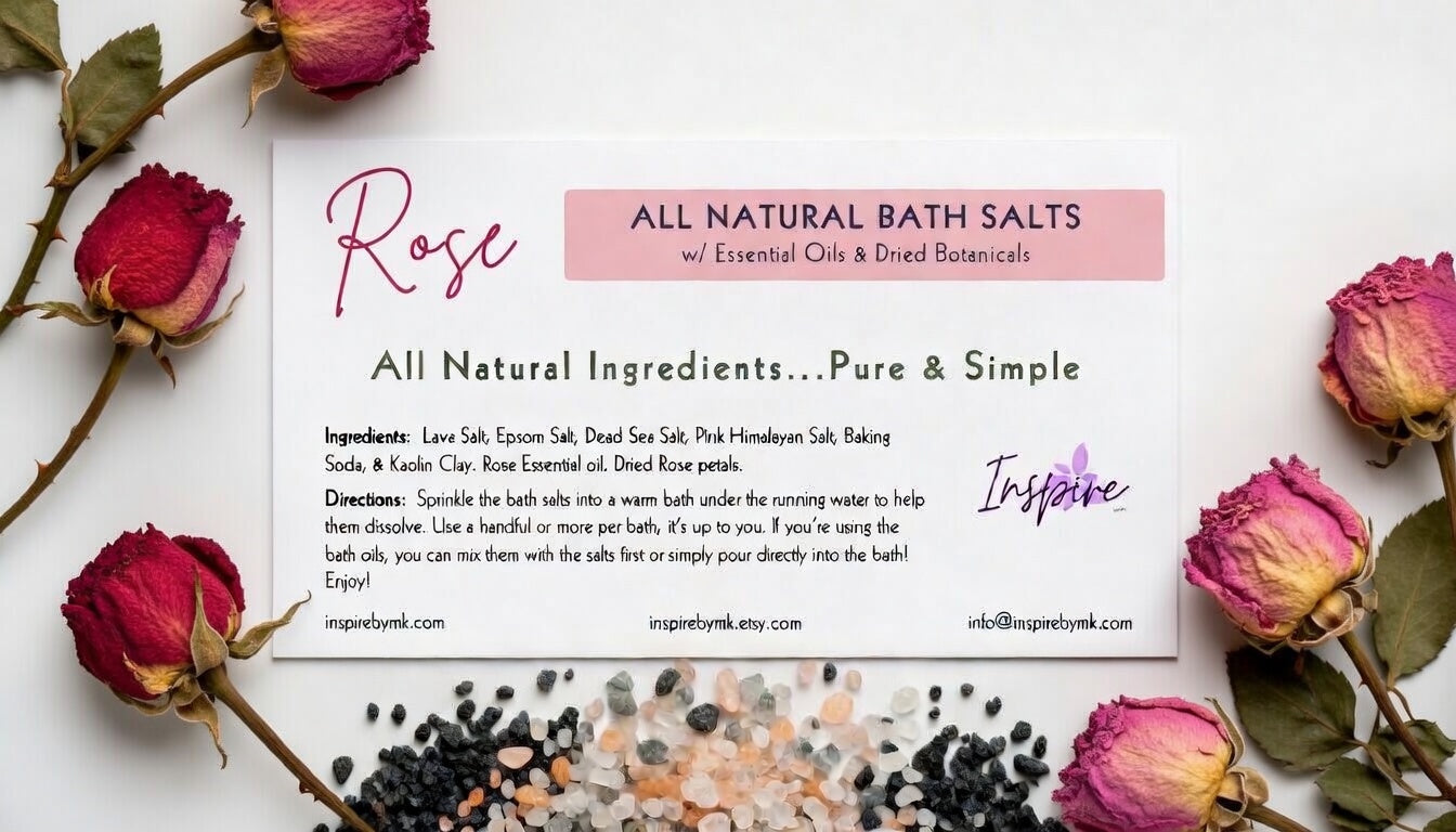 InspireByMK Rose Lava Bath Salts label surrounded by dried pink and red rose buds, with a colorful mix of lava salt, pink Himalayan salt, and dead sea salt scattered below. All-natural bath salts with rose essential oil and dried rose petals
