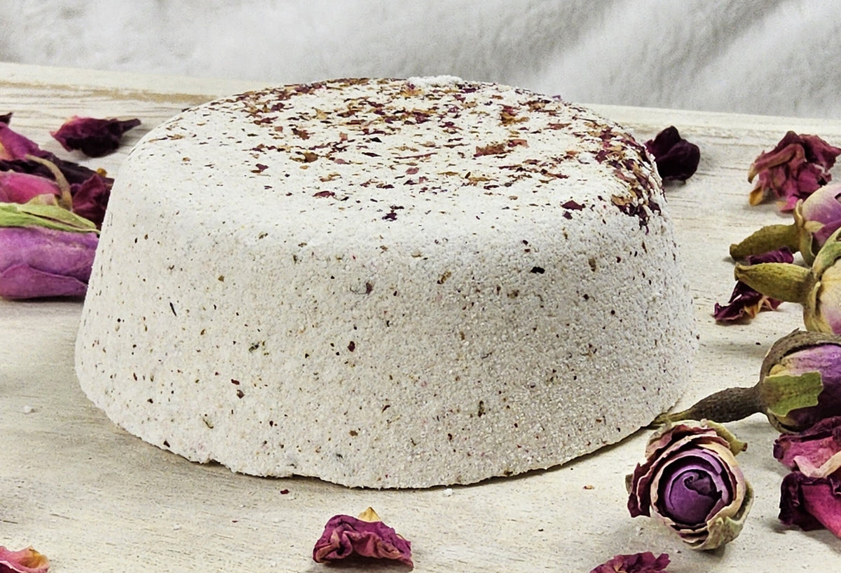 InspireByMK Eucalyptus shower steamer handcrafted dome with cream base and green dried eucalyptus leaves, surrounded by fresh eucalyptus stems showing pure eucalyptus essential oil with eucalyptus hydrosol for respiratory wellness and invigoration