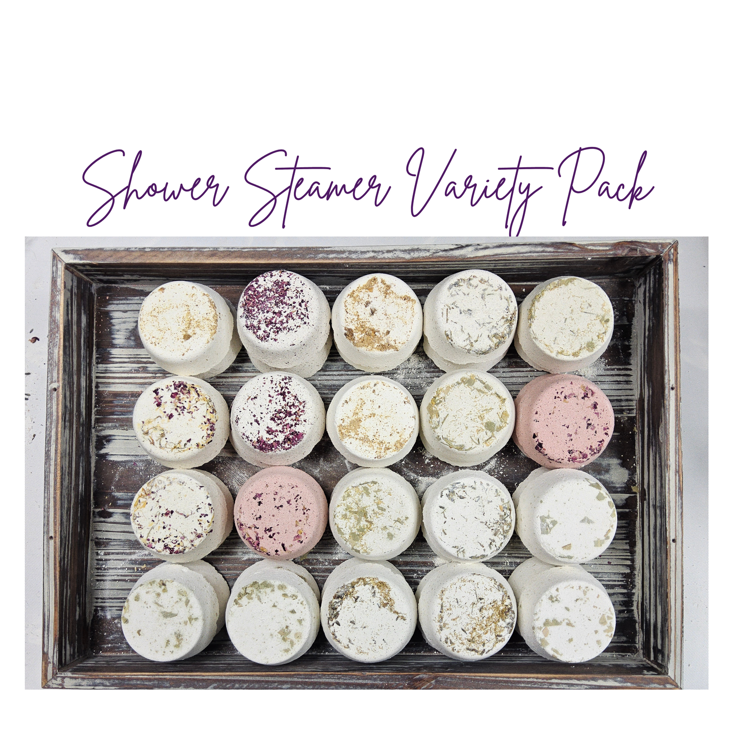 InspireByMK Shower Steamer Sample Pack featuring all 8 handcrafted scents — including rose, lavender, eucalyptus, citrus, and tranquility — topped with dried botanicals and arranged on a rustic wooden tray