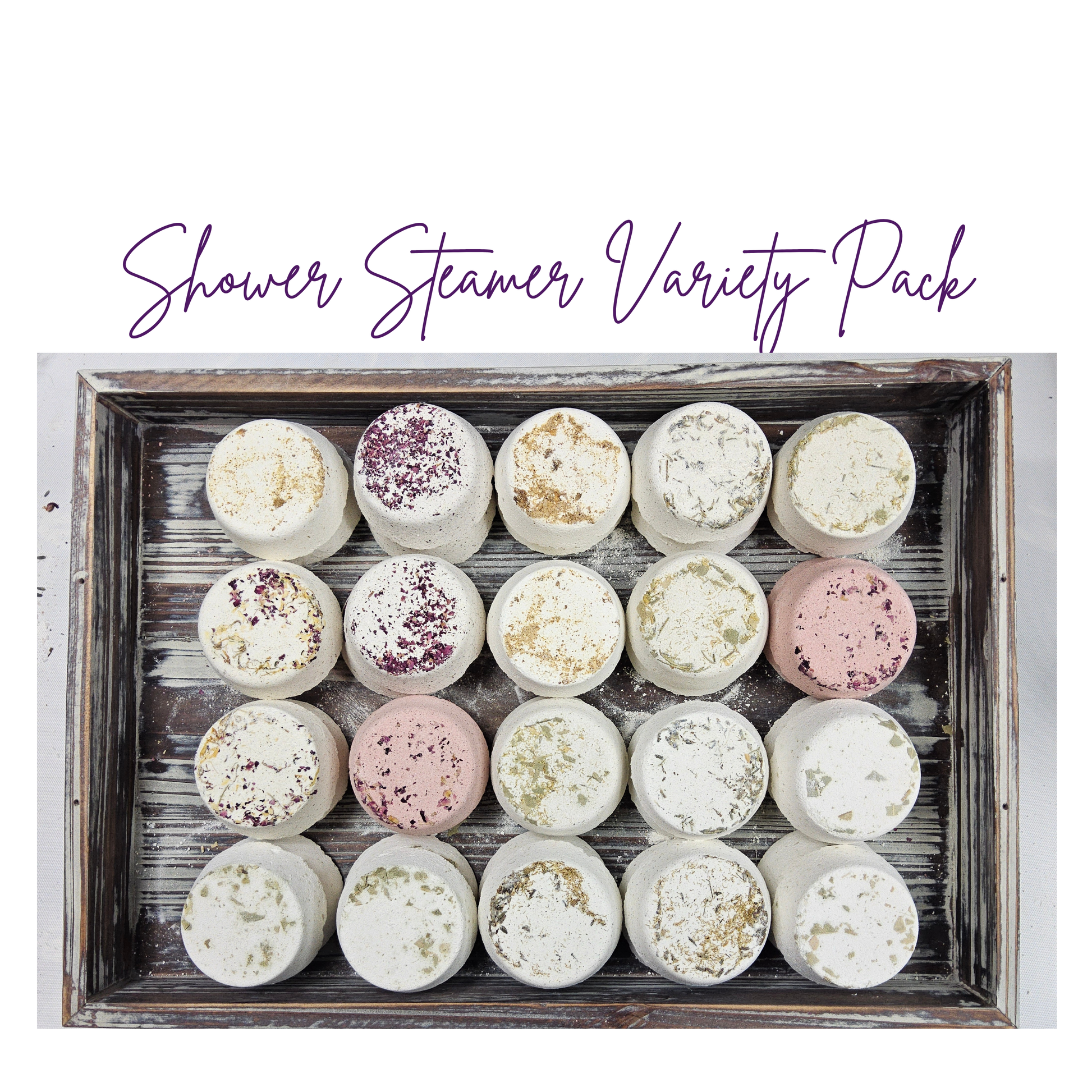 InspireByMK Shower Steamer Sample Pack featuring all 8 handcrafted scents — including rose, lavender, eucalyptus, citrus, and tranquility — topped with dried botanicals and arranged on a rustic wooden tray