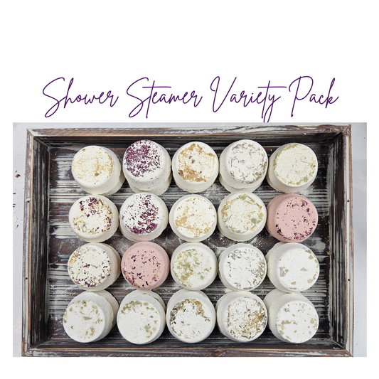 InspireByMK Shower Steamer Sample Pack featuring all 8 handcrafted scents — including rose, lavender, eucalyptus, citrus, and tranquility — topped with dried botanicals and arranged on a rustic wooden tray